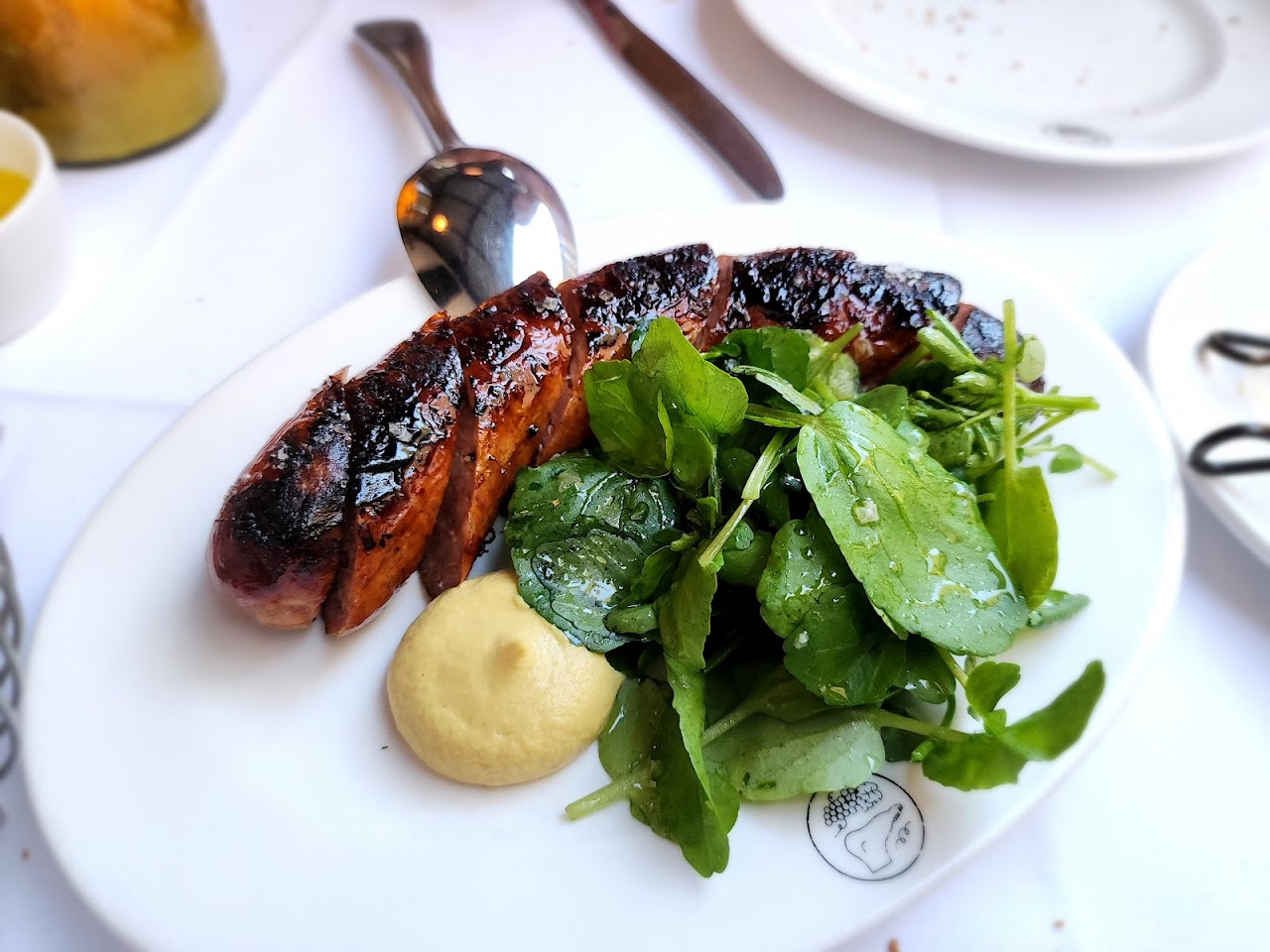 Grilled sausage with greens and mustard at Le Foote